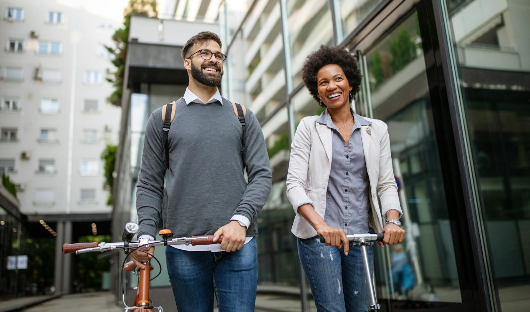 a man and woman with a scooter and a bicycle